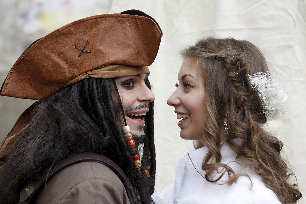 German Krasitsky, a cameraman from Russia, dressed as movie character Captain Jack Sparrow, and his bride Anastasiya smile during their wedding ceremony in the southern city of Stavropol, Russia. Krasitsky dressed as the Pirates of the Caribbean character and picked the film for the theme of his wedding as a surprise to his bride.