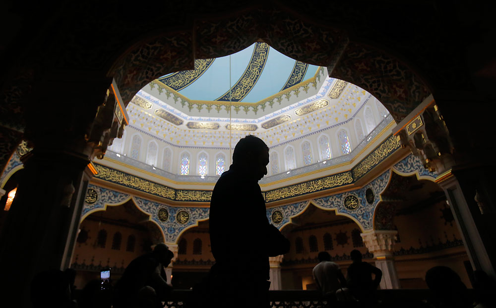 Muslims pray during Friday prayer service at Moscow's grand mosque in Rissia