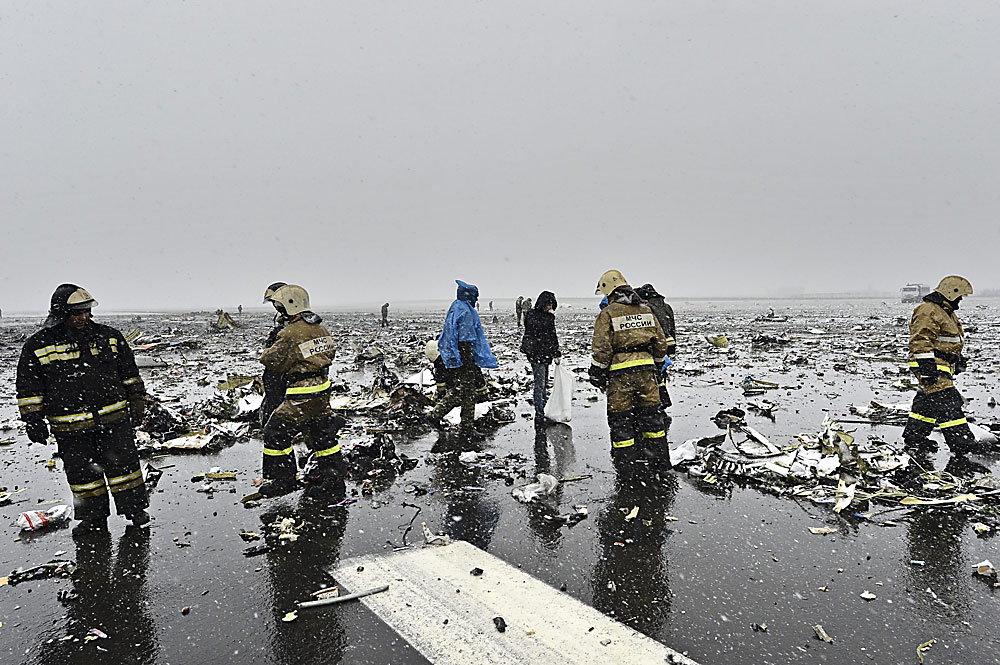 Russian Emergency Ministry employees among the wreckage of a crashed plane at the Rostov-on-Don airport, about 950 kilometers (600 miles) south of Moscow.