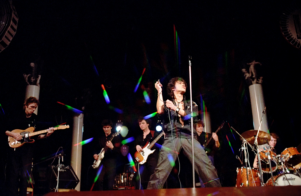 Viktor Tsoi (front) with his rock band Kino [Cinema] perform at the MELZ electo-lamp plant's Palace of Culture during a rock parade dedicated to Sergei Solovyov's Assa film premiere, Moscow, March 25, 1988. 