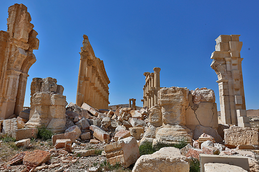In this picture taken on April 1, 2016, damage is seen in the ancient city of Palmyra in the central city of Homs, Syria. Explosions rocked the ancient town of Palmyra on Friday and on the horizon, black smoke wafted behind its majestic Roman ruins, as Syrian army experts carefully detonated hundreds of mines they say were planted by Islamic State militants before they fled the town.