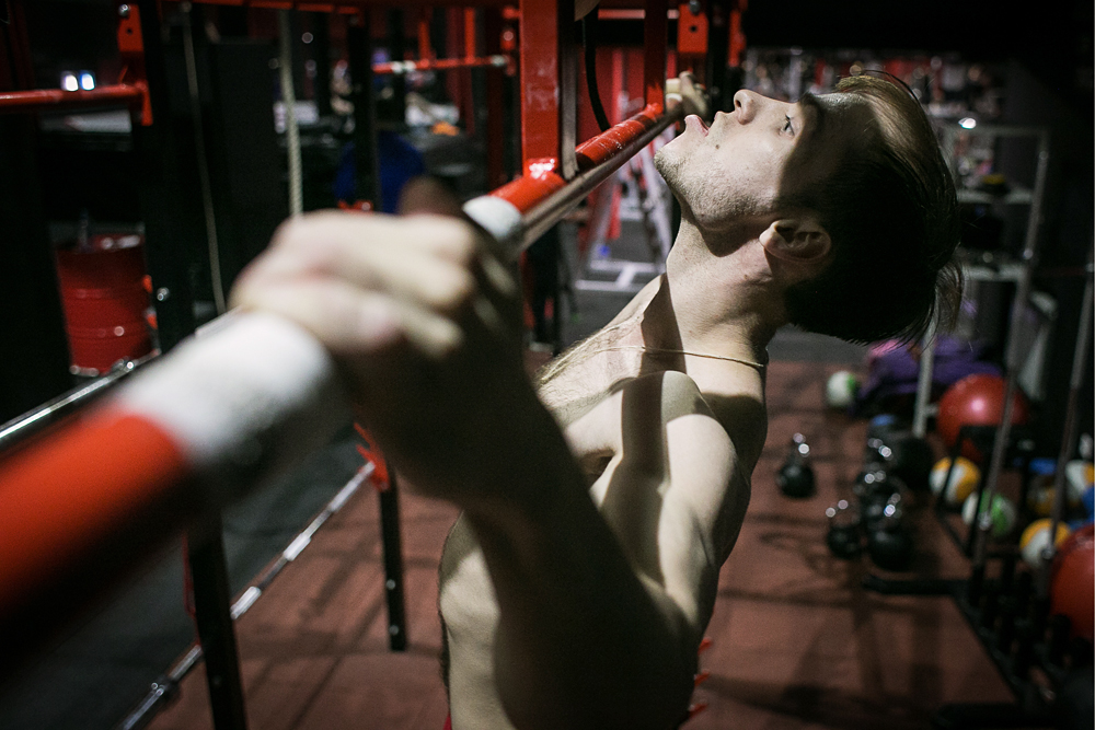 TOMSK, RUSSIA. APRIL 12, 2016. Russian athlete Viktor Filippov during a training session in a gym. Filippov has broken the pull-ups world record by doing 75 pull-ups in a minute. That beats the previous record by 16.
