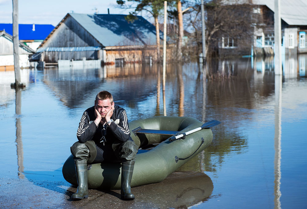 A local resident near private houses flooded due to a freshet, in the town of Ishim, Tyumen region