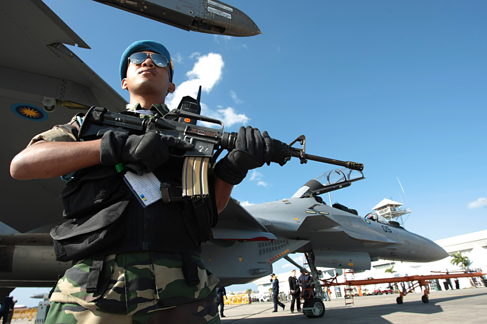 Malaysian soldier armed with rifle stands on guard near Royal Malaysian Air Force Sukhoi Su-30MKM jet fighters at the 2007 Langkawi International Maritime & Aerospace Exhibition (LIMA 2007) in Malaysia. 