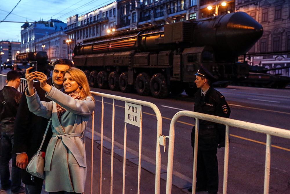 A couple takes a selfie in Moscow during a rehearsal for the 2017 Victory Day parade