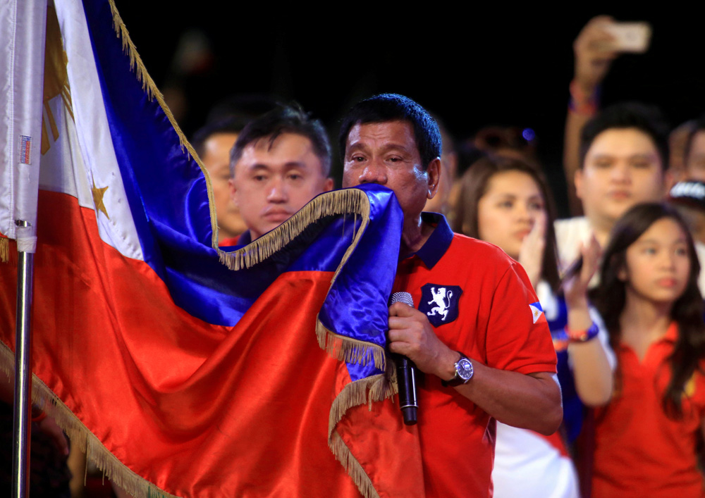 President-elect Rodrigo Duterte kisses the Philippine flag in Manila, Philippines.