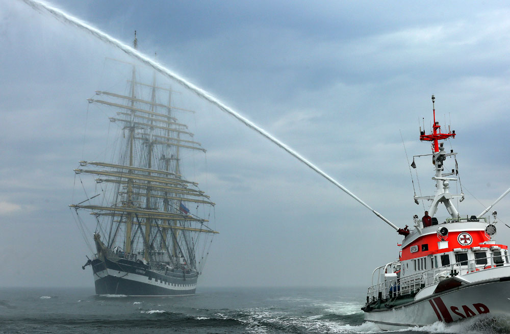 Приветстван c водни струи, руският ветроходен кораб „Крузенщерн“ пристига в Росток, Германия.