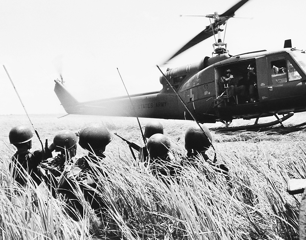 A Vietnamese troop reconnaissance unit walks hip-deep in water towards helicopter in the Mekong Delta on Oct. 13, 1964.