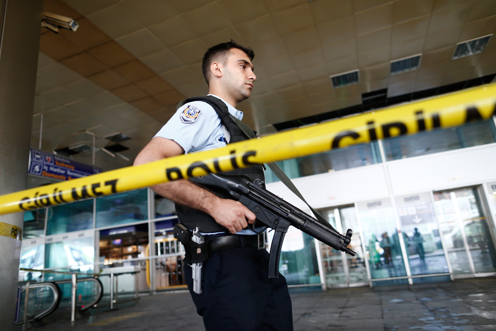  An armed Turkish policeman patrols behind a police line after multiple suicide bomb attacks at Ataturk international airport in Istanbul, Turkey, 29 June 2016. 