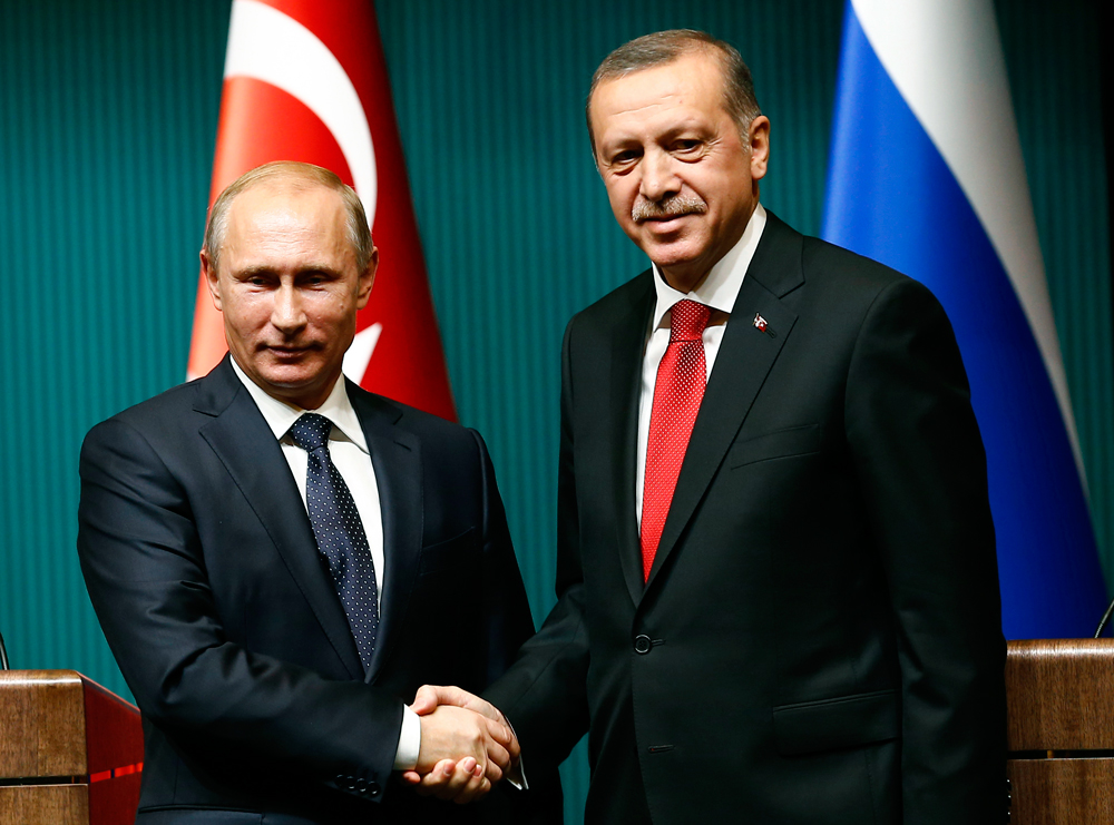 Putin shakes hands with Erdogan after a news conference at the Presidential Palace in Ankara, December 1, 2014.
