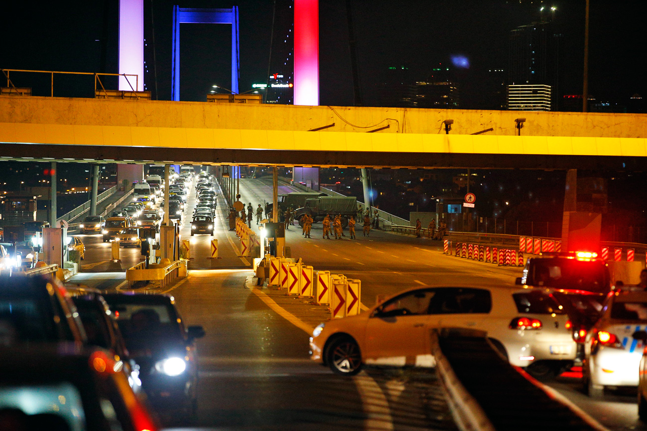 Turkish soldiers block Istanbul's iconic Bosporus Bridge on Friday, July 15, 2016, lit in the colours of the French flag in solidarity with the victims of Thursday's attack in Nice, France. A group within Turkey's military has engaged in what appeared to be an attempted coup, the prime minister said, with military jets flying over the capital and reports of vehicles blocking two major bridges in Istanbul. Prime Minister Binali Yildirim told NTV television: "it is correct that there was an attempt," when asked if there was a coup. 