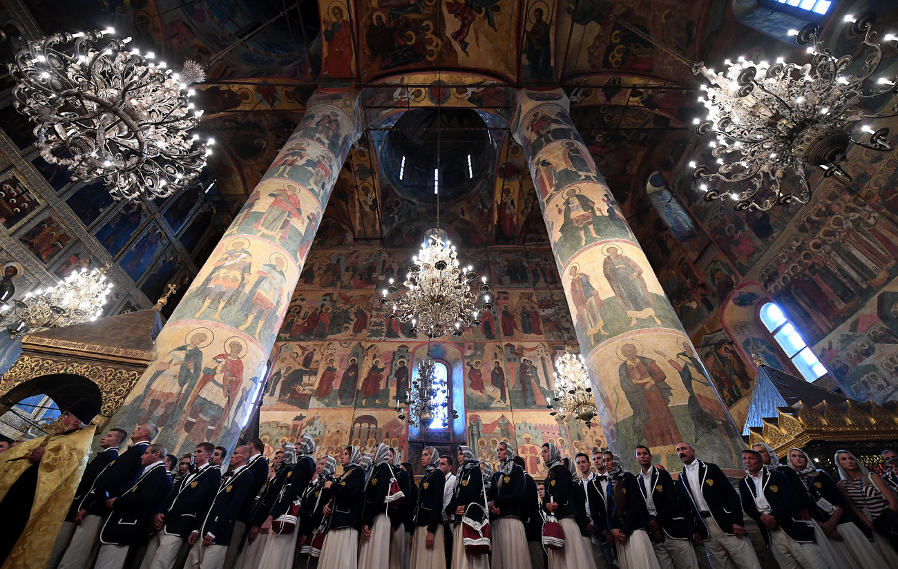 Членовете на олимпийския отбор на Русия чакат благословия от патриарха Кирил по време на службата в Успенския събор в Кремъл.
