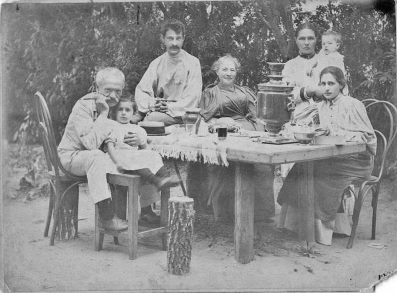 Life in the new Russia required everyone to work, not sit around sipping tea and strolling along leafy paths. / At the dacha: Group portrait, 1896.