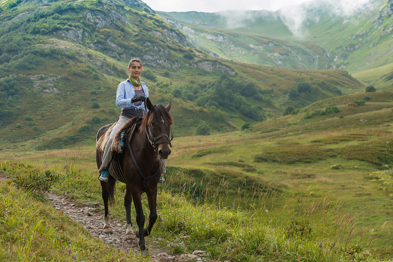 KRASNODAR TERRITORY, RUSSIA - AUGUST 30, 2016: A tourist rides a horse at the Kavkazsky Nature Reserve. 