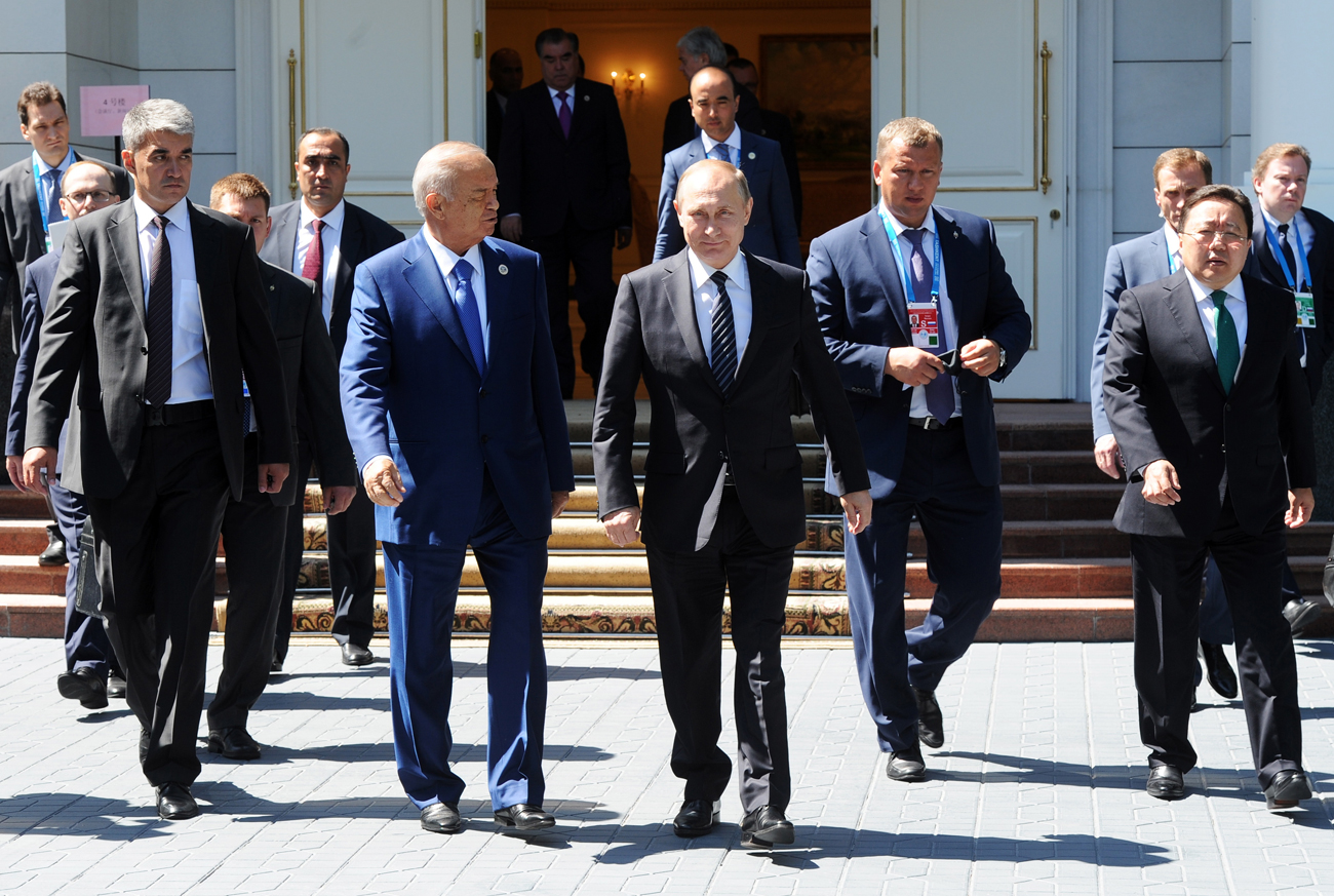 Uzbekistan's President Islam Karimov, Russia's President Vladimir Putin, and Mongolia's President Tsakhiagiin Elbegdorj (right) following a meeting of the SCO Heads of State Council