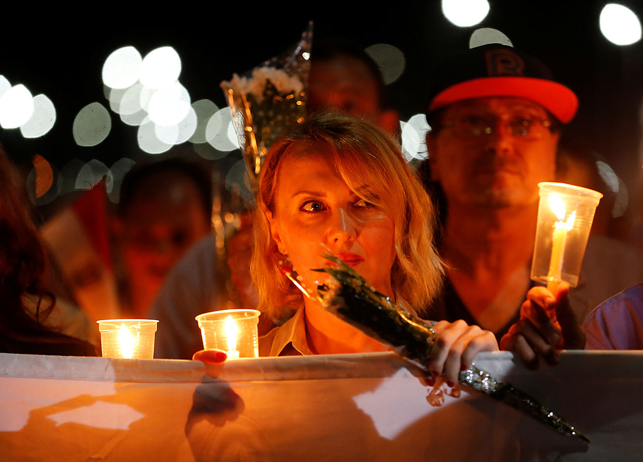 Луѓе со свеќи и знамето на РФ на „Плоштадот на мирот“ во текот на церемонијата на одбележување на првата годишнина од падот на рускиот авион А321 во одморалиштето Шарм ел Шеик на Црвеното море, Египет. 30 октомври 2016.