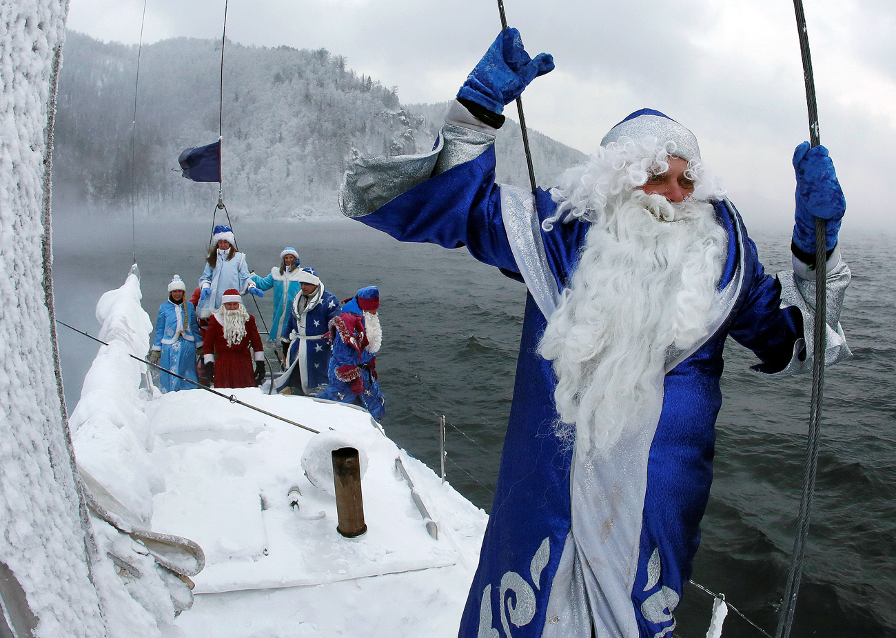 Members of the "Skipper" yacht club dressed as Ded Moroz, the Russian equivalent of Santa Claus, and his granddaughter Snegurochka (Snow Maiden) sail a yacht along the Yenisei River while marking the end of the sailboat season, with the air temperature at about minus 21 degrees Celsius (minus 5.8 degrees Fahrenheit), outside the Siberian city of Krasnoyarsk, Russia
