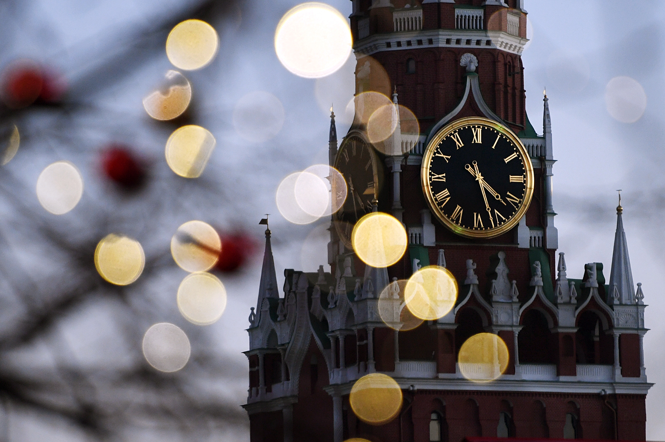 Festive lights and Spasskaya Tower of the Moscow Kremlin on Red Square.