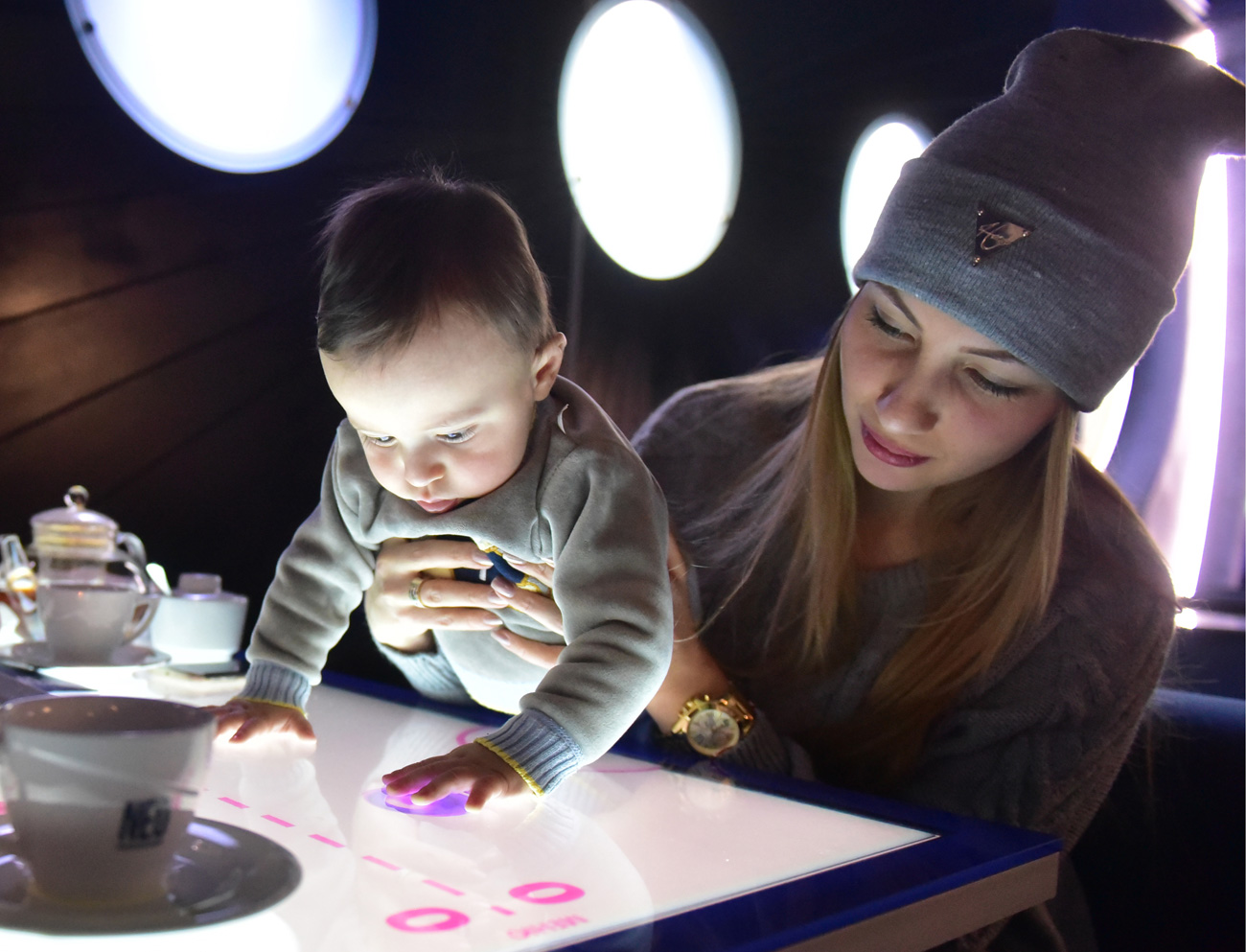 VLADIKAVKAZ, RUSSIA  A woman and a baby at the NEO interactive restaurant. The restaurant is equipped with interactive tables where people can view a list of dish ingredients, place an order or play games while waiting for meal. 
