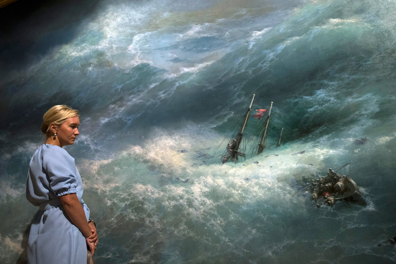 A woman looks at the "Wave" painting by Ivan Aivazovsky, Russian Romantic painter, who is considered one of the greatest marine artists in history, in Tretyakov Picture Gallery on Krymsky Val in Moscow, Russia