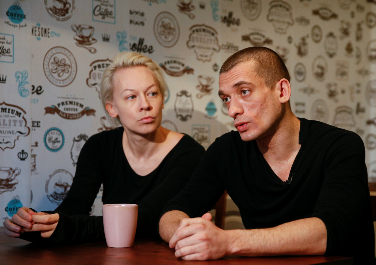 Russian artist Pyotr Pavlensky (R) speaks while his partner Oksana Shalygina looks on during an interview with Reuters in Kiev, Ukraine.