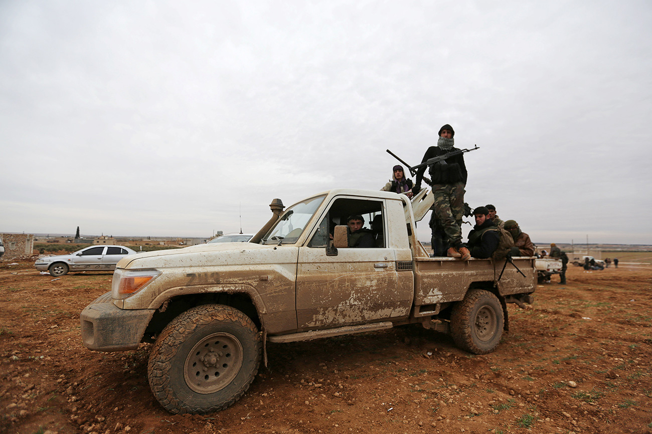 Rebel fighters ride a pick-up truck on the outskirts of the northern Syrian town of al-Bab, Syria Jan. 14, 2017.