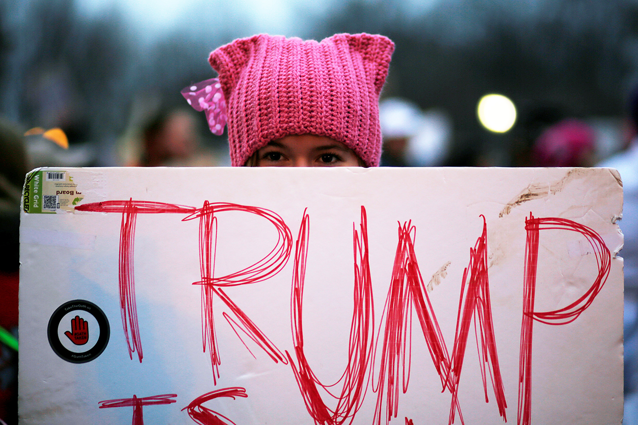 A woman wearing pink pussy protest hat poses for a photograph during the Women's March on Washington, following the inauguration of U.S. President Donald Trump, in Washington, DC, U.S. ,Jan. 21, 2017. 