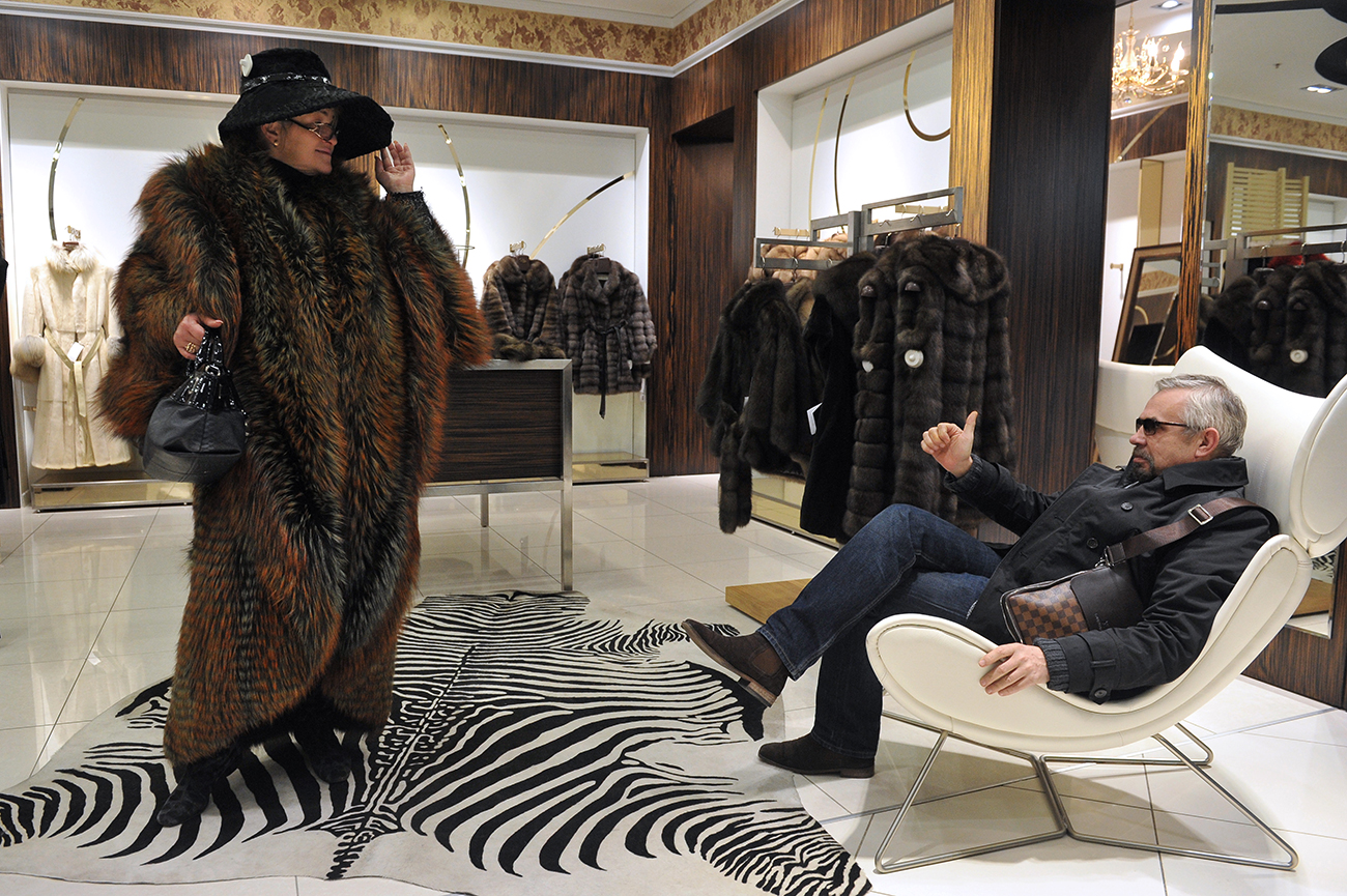 A customer tries on a fur coat in the Fur and Leather World shop in Moscow.