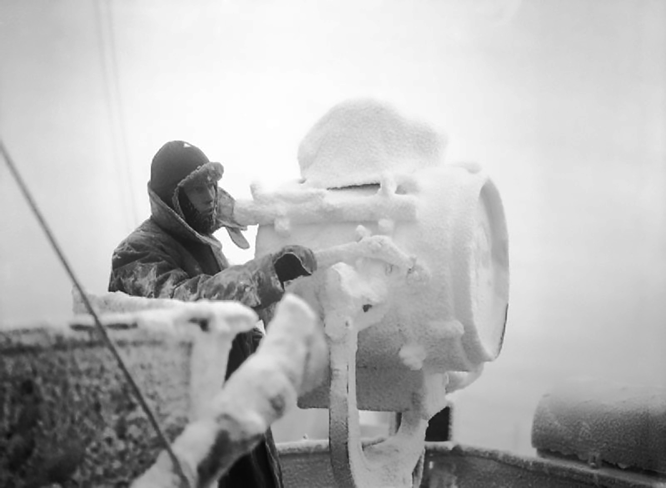 Ice forms on a 20-inch signal projector on the cruiser HMS Sheffield while she is helping to escort an Arctic convoy to Russia.
