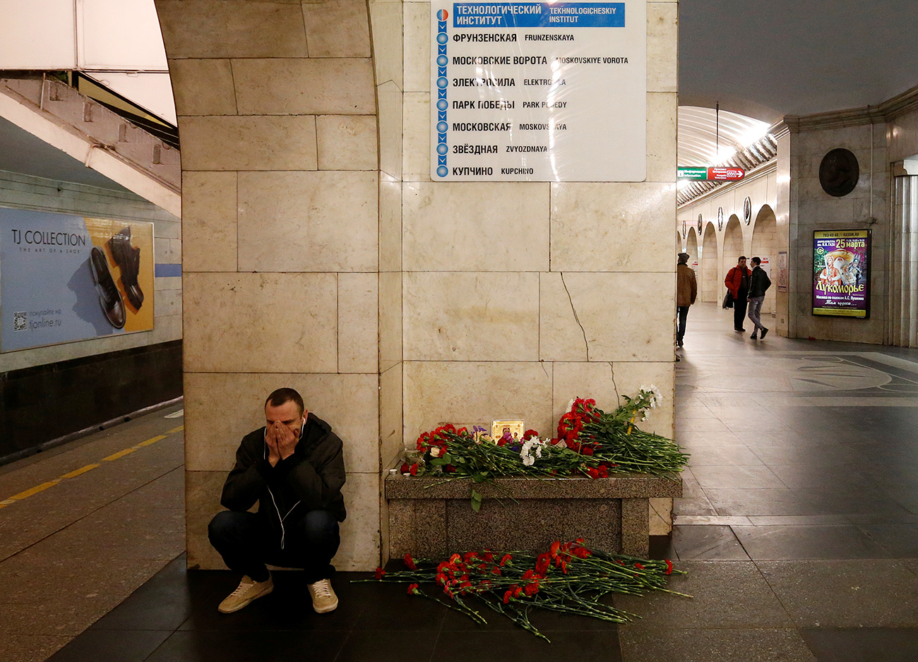 A man reacts next to a memorial site for the victims of a blast in St. Petersburg metro, at Tekhnologicheskiy institut metro station in St. Petersburg, April 4, 2017. 