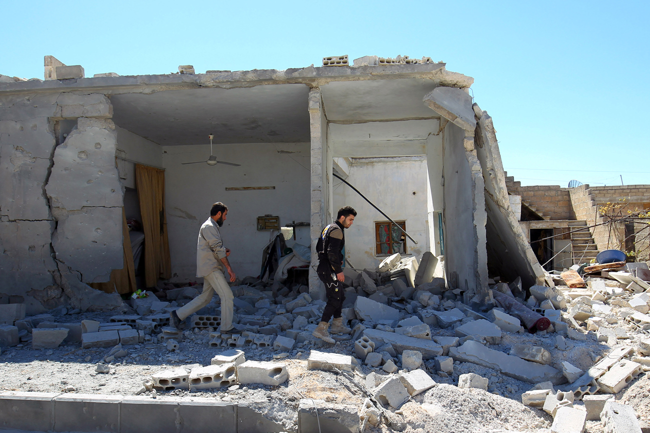 Civil defense members inspect the damage at a site hit by airstrikes, in the town of Khan Sheikhoun in rebel-held Idlib, Syria, April 5, 2017.