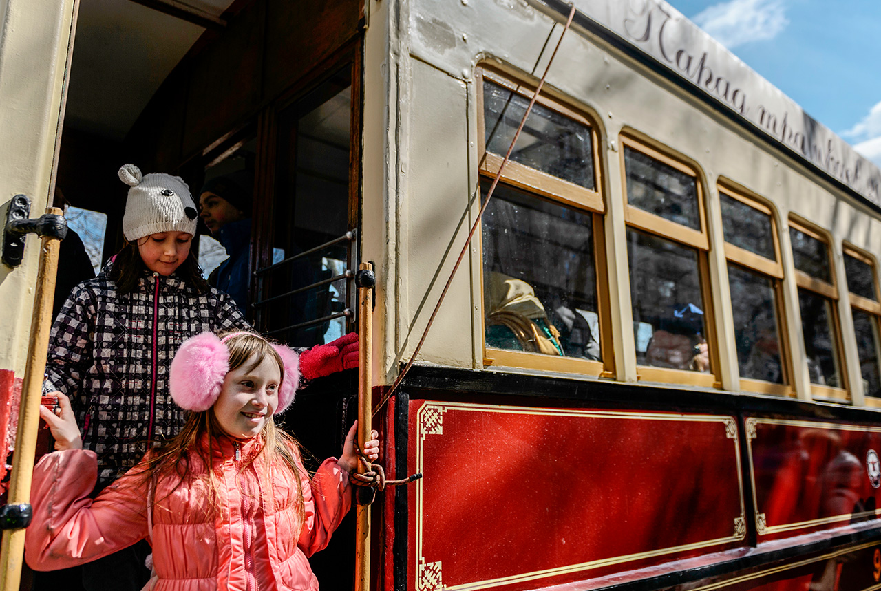 Children enjoy the vintage tram parade. 