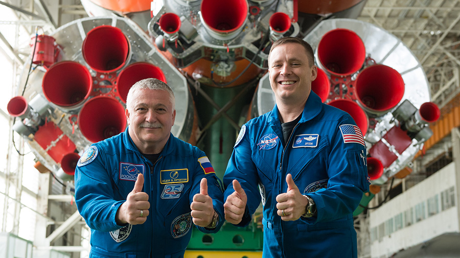 Fyodor Yurchikhin and Jack Fischer give a “thumbs up” in front of the Soyuz rocket.