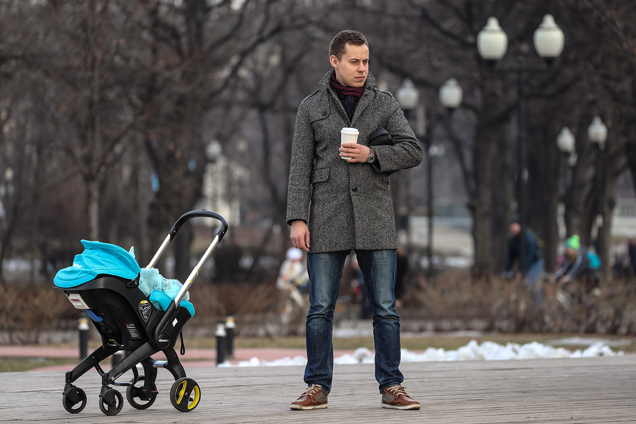 A man walking with a baby in Moscow’s Gorky Park. 