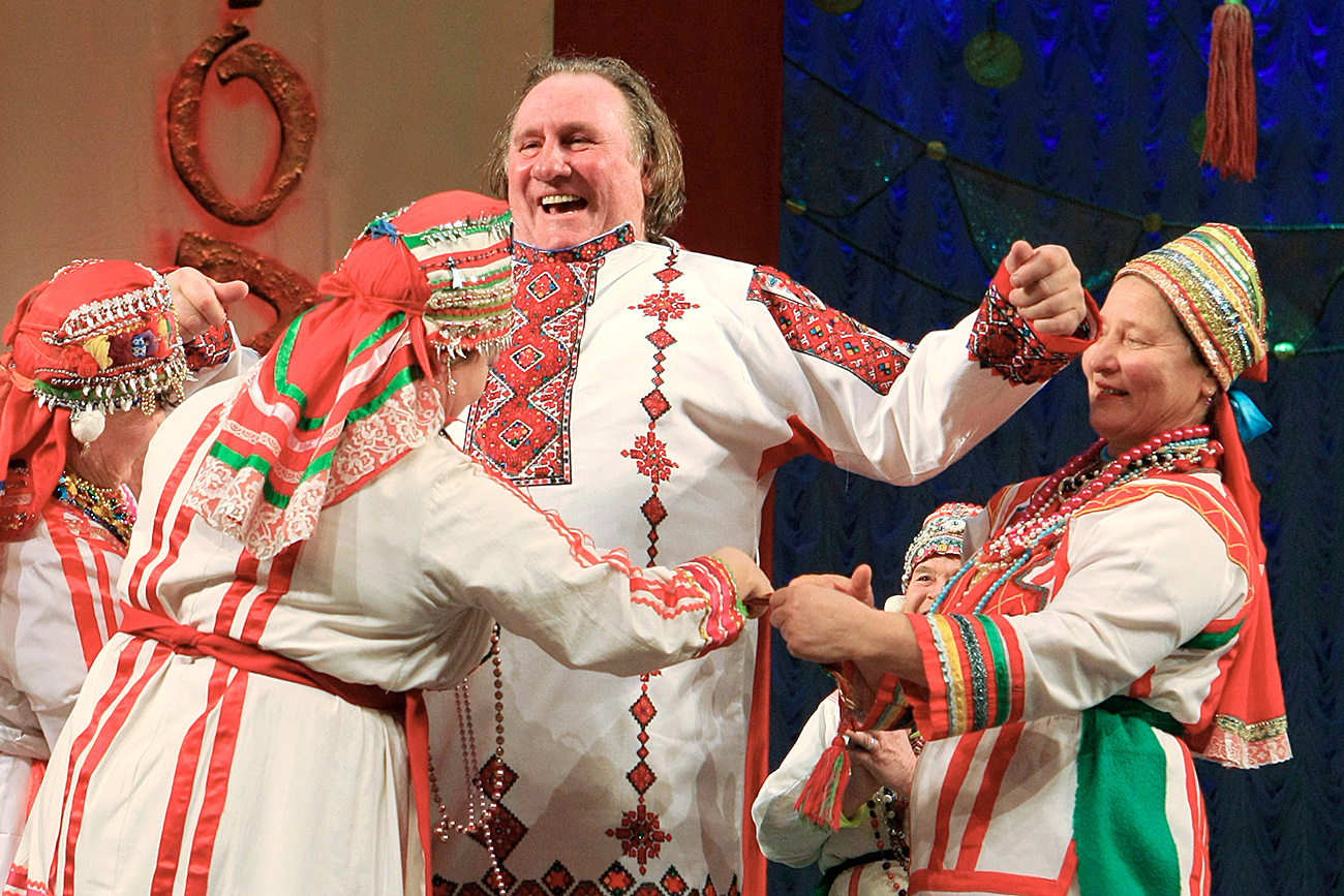 French actor Gerard Depardieu, who was granted Russian citizenship, puts on a Mordovian national shirt on stage in the Theatre of Opera and Ballet in Saransk.