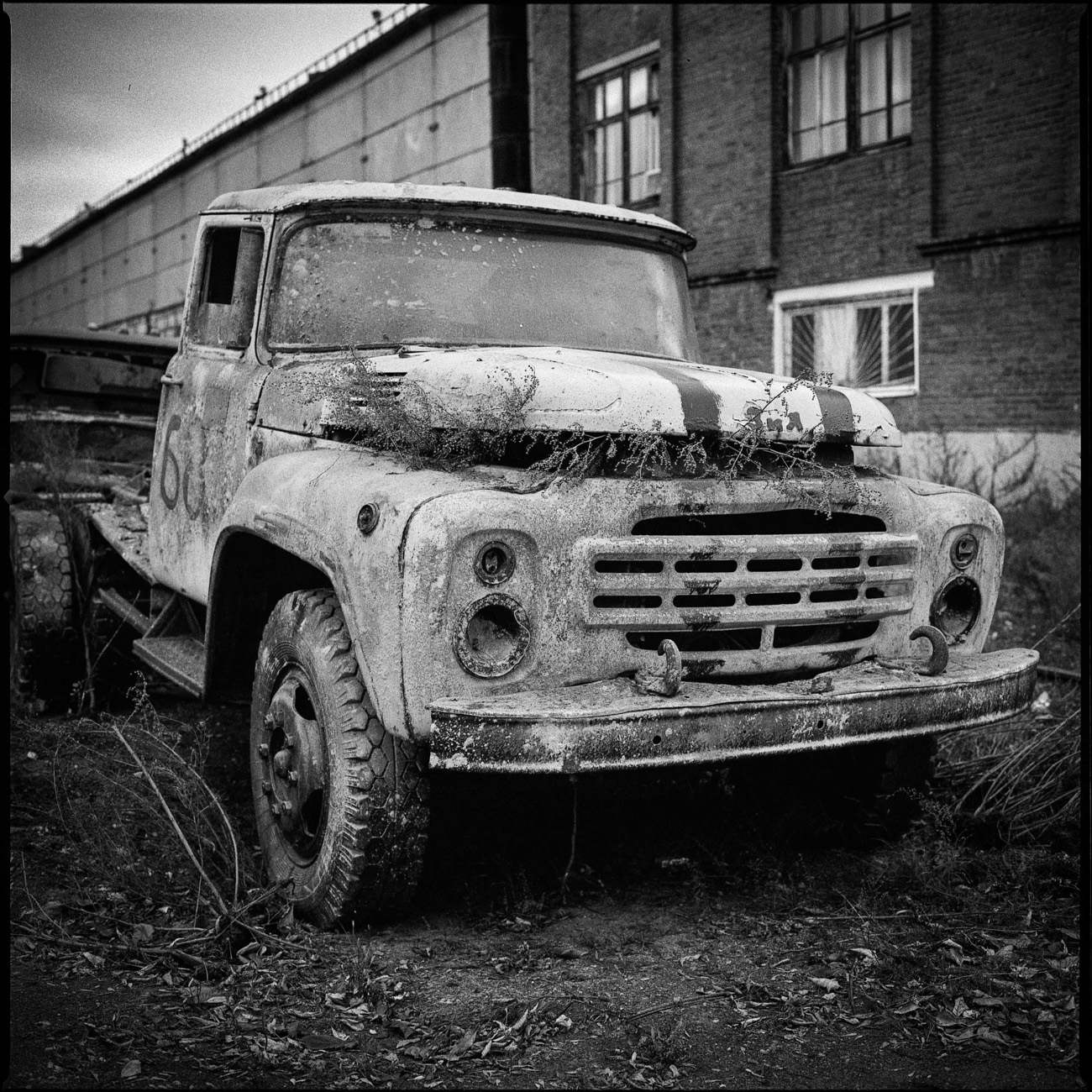 An abandoned ZIL 130 awaits its turn for the scrap heap. Back in 1963, it was one of the most modern trucks of its time. It was even given the USSR mark of quality.
