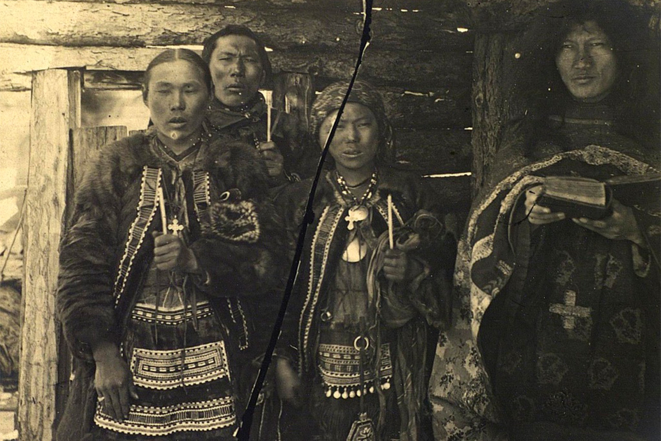 The wedding`s size, number of guests, food, and gifts depended on the family's wealth. There were almost always horses, koumiss (low-alcoholic drink made of mare`s milk), and meat, lots of meat. (Wedding ceremony: Groom, bride, and shaman (right), 1885-1899) 