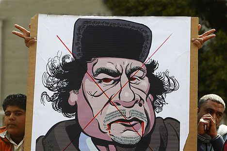 Protesters display a caricature of Libyan leader Muammar Gaddafi outside the Arab League headquarters in Cairo during an emergency meeting of the League's foreign ministers to discuss Libya. Source: REUTERS/Vostock Photo/Amr Abdallah Dalsh 