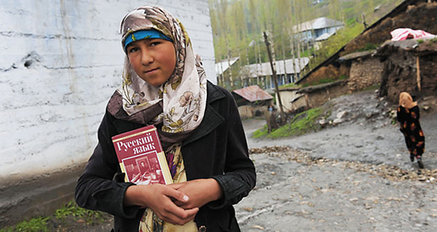 A tajikian girl holding a Russian language book on her way to school.   Source: RIA Novosti