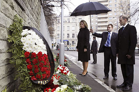 Russia's First Lady Svetlana Medvedeva takes part in a flower-laying ceremony, with Polish Ambassador to Russia Wojciech Zajączkowski, outside the Polish embassy to mark the first anniversary of the plane crash. Source: Reuters / Vostock Photo