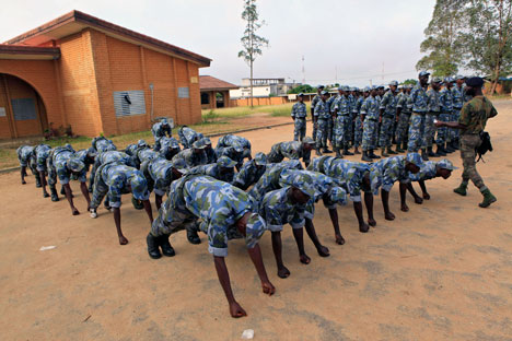 Soldiers from the 'Invisible Commandos,' loyal to Ibrahim Coulibaly, are punished by having to hold themselves up on their fists, during training in the PK-18 area of the Abobo neighborhood, in Abidjan, Ivory Coast Tuesday, April 19, 2011. AP Photo/R