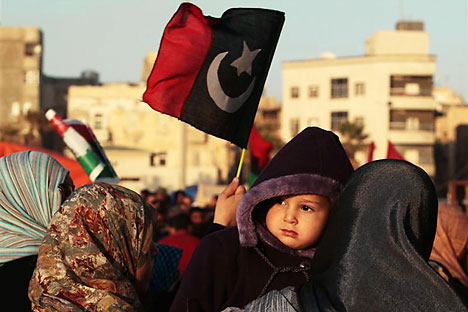 A protester holds her baby during an anti-Gaddafi demonstration in Benghazi.   Source: Reuters/Vostock photo