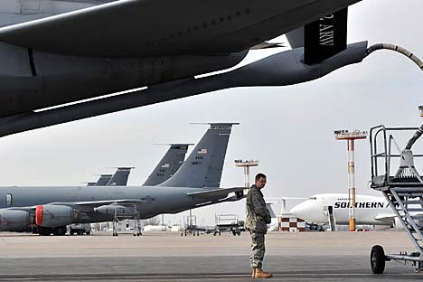 A US soldier stands near a plane bound for Afghanistan, as it fuels up at the Manas Transit Center some 30kms from Bishkek.   Source: AFP/East News