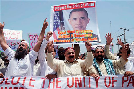 Activists of a local social group Muthahida Shehri Mahaz hold up a banner depicting U.S. President Barack Obama, during a rally to condemn the killing of al-Qaida leader Osama bin Laden, in Multan, Pakistan, Sunday, May 8, 2011.   Source: AP