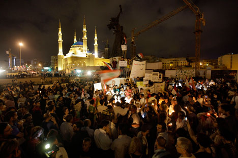 Lebanese intellectuals and journalists protest during a vigil sit-in to show their support to the Syrian protesters who demonstrate against the Syrian President Bashar Assad, at the Martyrs square, in downtown of Beirut, Lebanon, on Monday Aug. 8, 20