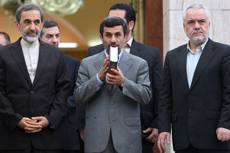 Iranian President Mahmoud Ahmadinejad kisses the Quran during a departure ceremony for him before leaving for Turkey to attend an international conference in May 2011.   Source AP