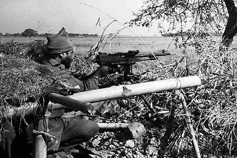 An Indian Army machine gunner fires at Pakistani positions in a village across an open field, 1,500 yards inside the East Pakistan border at Dongarpada on Dec. 7, 1971