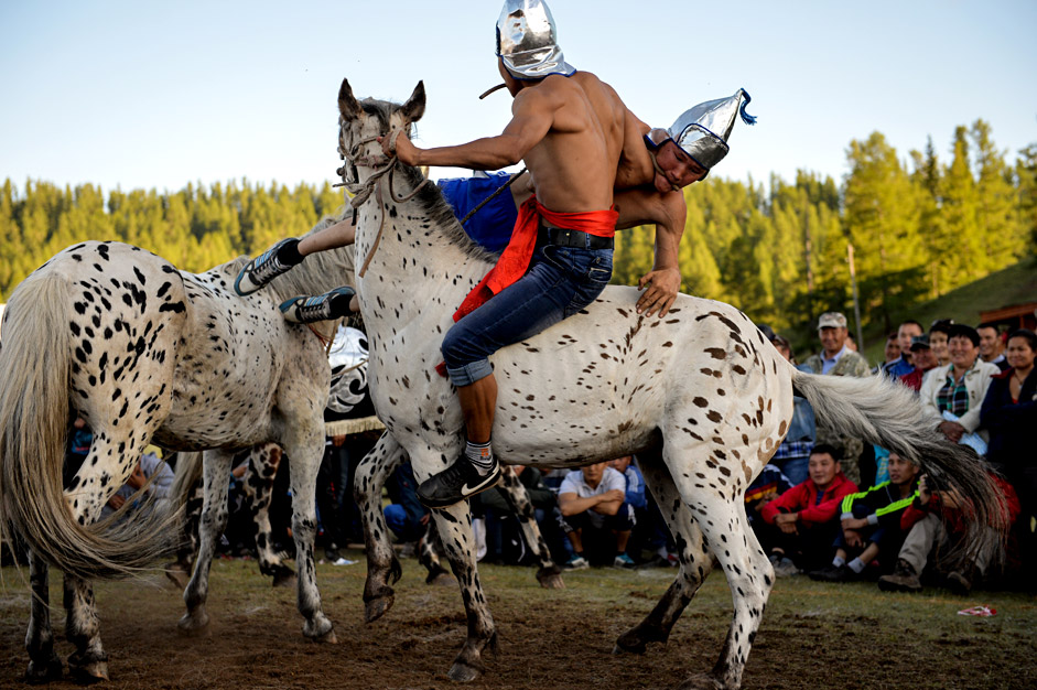 Two Telengits horseback wrestlers take each other on as part of a celebration of the 150th anniversary of the unification of the Telengits people and Russia on June 19