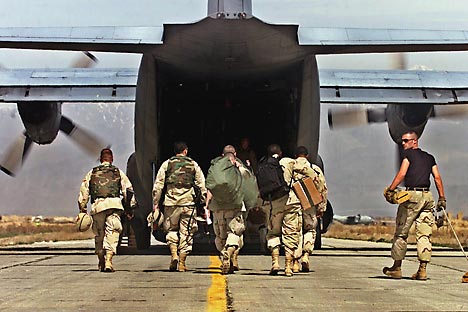 U.S. Army soldiers prepare to board a C-130 aircraft at the army base flightline in Bagram, Afghanistan, for redeployment to Kandahar, Afghanistan. Source: AP