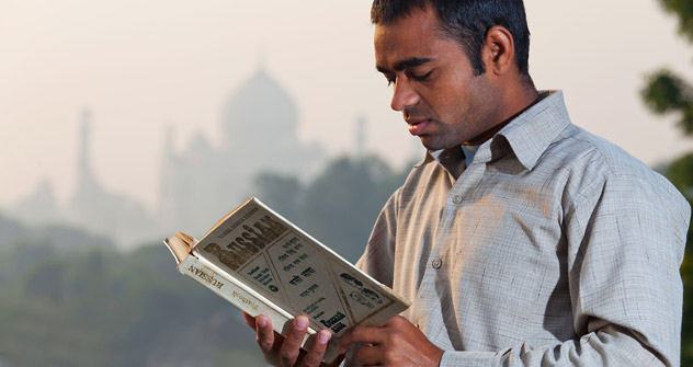 An Indian student reading a Russian textbook.